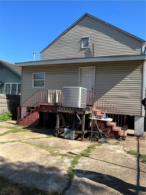 rear view of property featuring central air condition unit