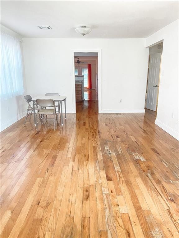 empty room with light hardwood / wood-style floors and ceiling fan