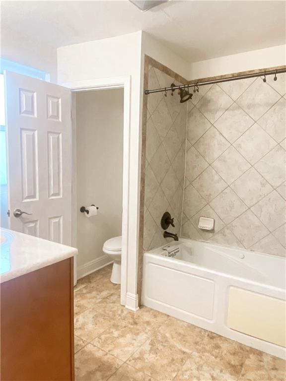 full bathroom with tiled shower / bath combo, vanity, tile floors, and toilet