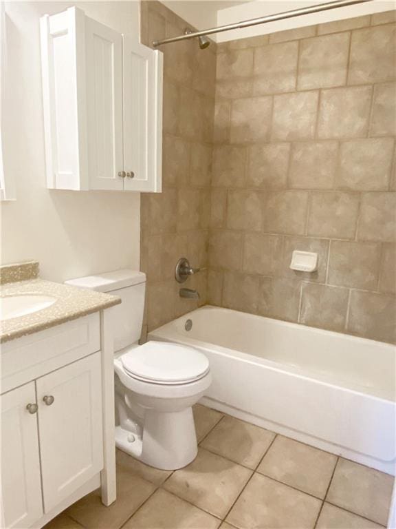 full bathroom featuring tile flooring, vanity, toilet, and tiled shower / bath