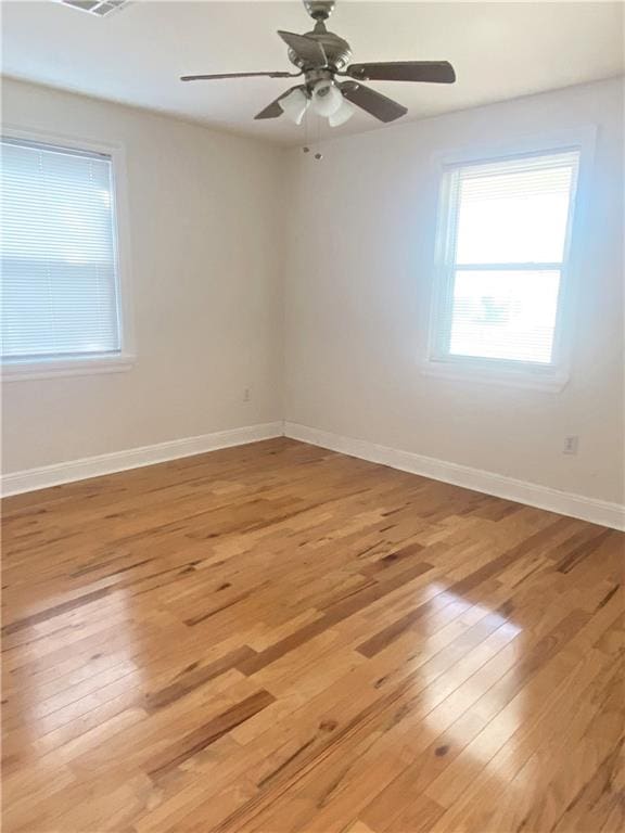 unfurnished room with ceiling fan and light hardwood / wood-style flooring