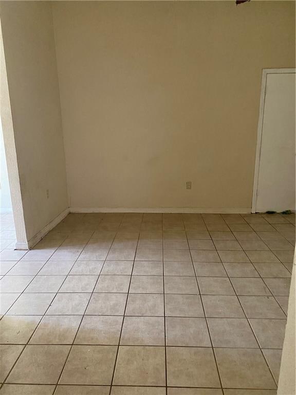 spare room featuring light tile floors