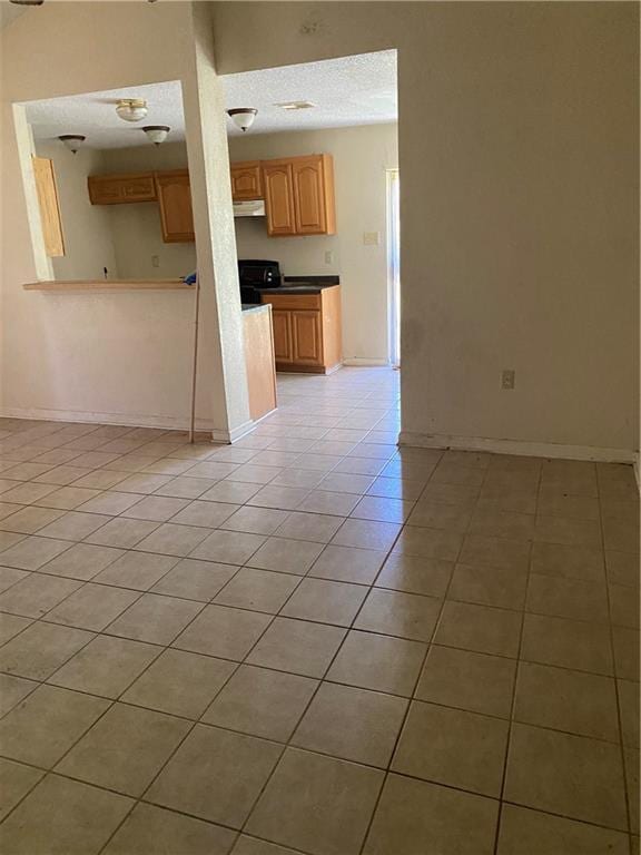 unfurnished living room with light tile floors