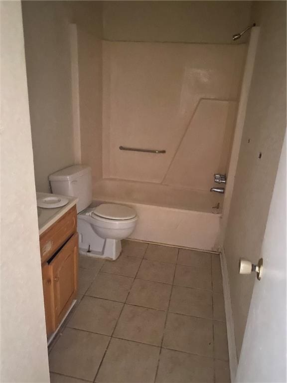 full bathroom with tile floors, toilet, vanity, and washtub / shower combination