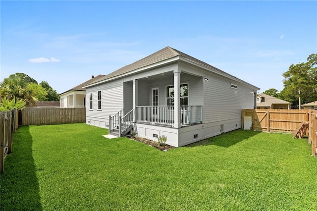 rear view of house featuring a yard