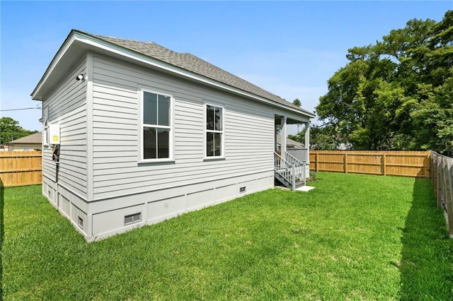 view of side of home featuring a lawn