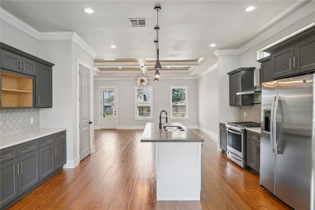 kitchen with stainless steel fridge, tasteful backsplash, hardwood / wood-style flooring, and range with gas cooktop