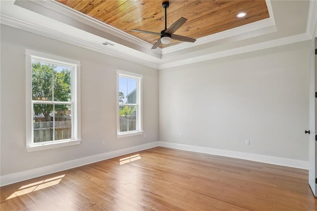 spare room with ceiling fan, crown molding, wood ceiling, light hardwood / wood-style flooring, and a tray ceiling