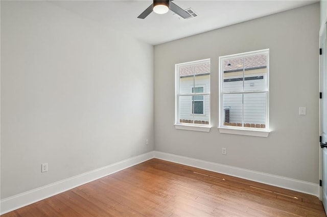 unfurnished room with hardwood / wood-style floors and ceiling fan