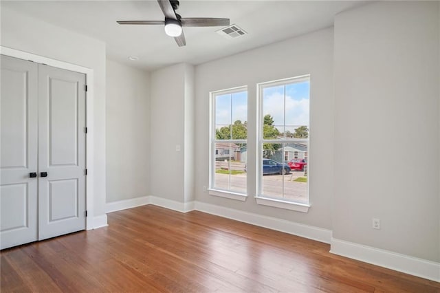 spare room with ceiling fan and dark hardwood / wood-style floors