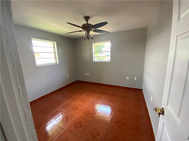 spare room featuring ceiling fan and tile floors