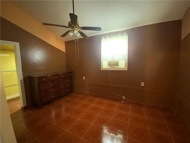 unfurnished bedroom with dark tile floors and ceiling fan