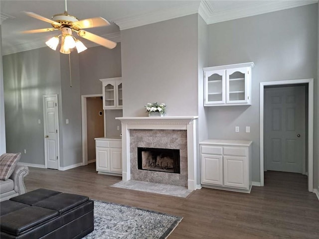 living room featuring ornamental molding, ceiling fan, and dark wood-type flooring