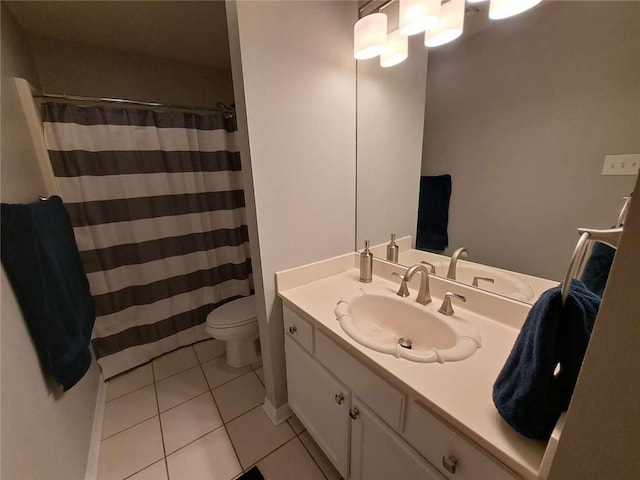 bathroom with toilet, tile flooring, and oversized vanity