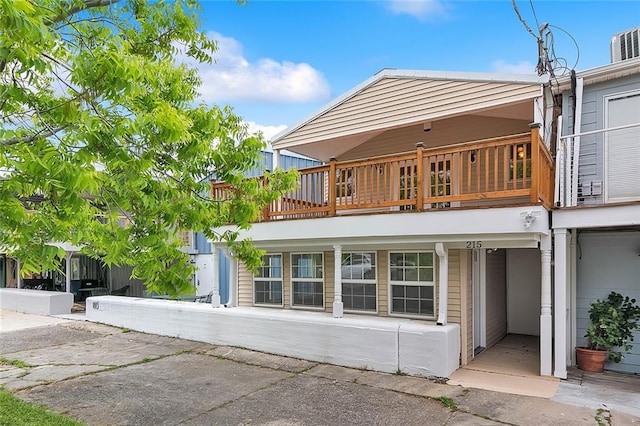 back of house featuring a balcony