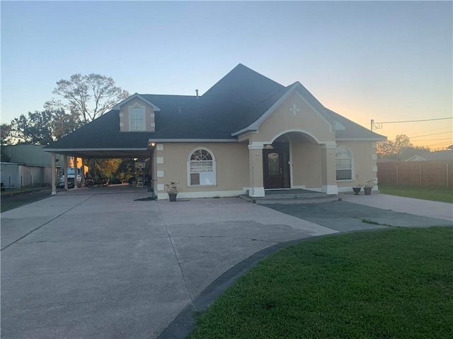 view of front of house featuring a lawn and a carport