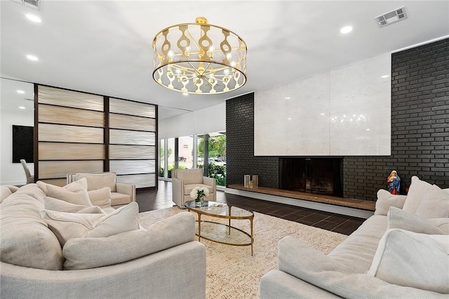 living room featuring a large fireplace and a chandelier