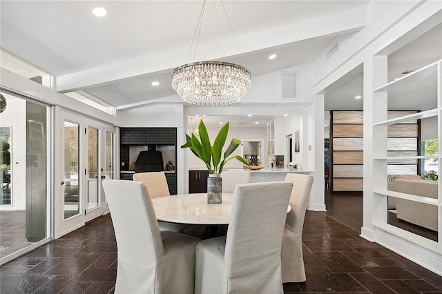 dining room with a chandelier, dark tile floors, french doors, and lofted ceiling with beams