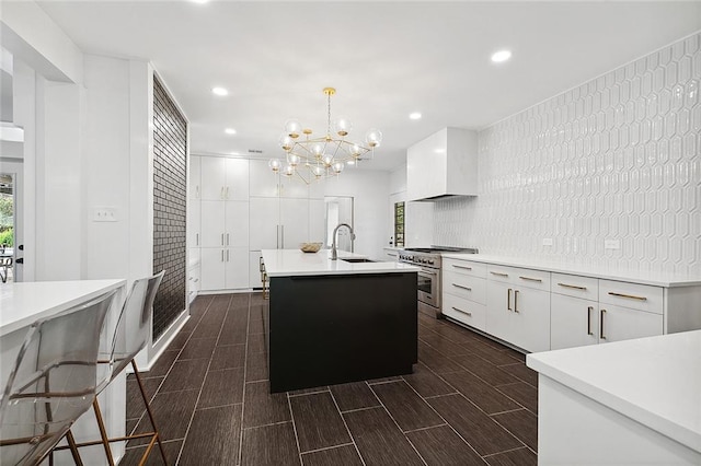 kitchen with white cabinets, a chandelier, high end stainless steel range oven, and pendant lighting