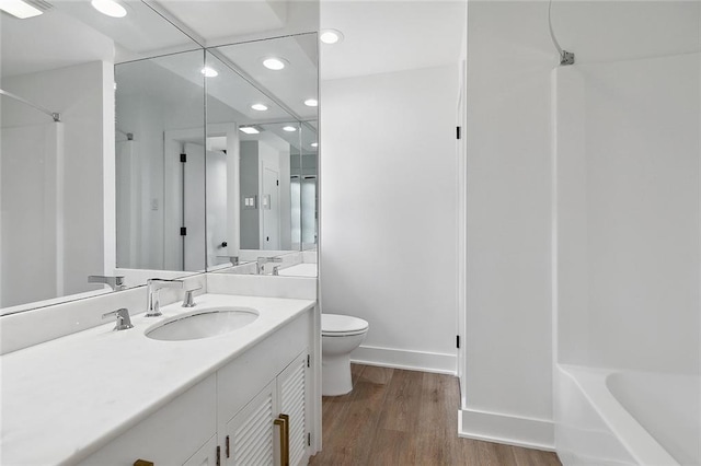 full bathroom with wood-type flooring, shower / bathtub combination, toilet, and large vanity