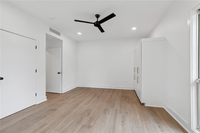 empty room featuring ceiling fan and light hardwood / wood-style flooring