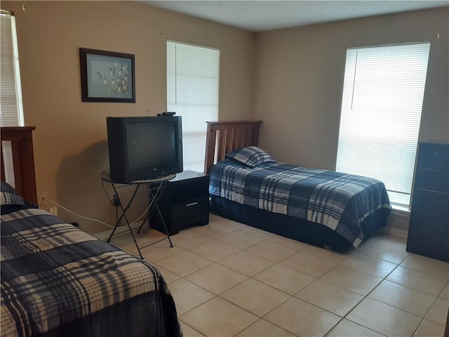 bedroom with light tile floors