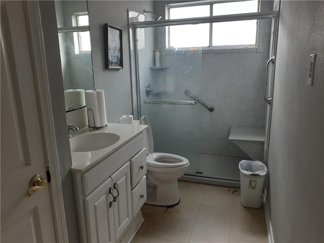 bathroom with a shower with shower door, tile flooring, toilet, and vanity