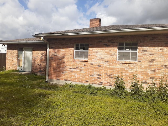 rear view of house with a yard