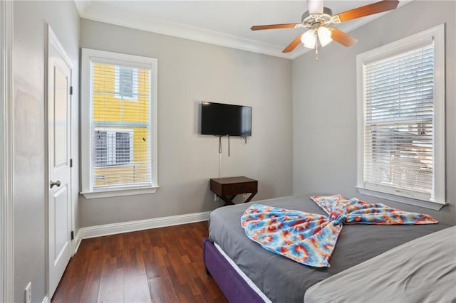 bedroom with ceiling fan, multiple windows, crown molding, and dark wood-type flooring