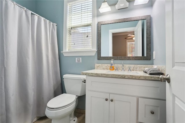 bathroom featuring toilet, tile flooring, ceiling fan, and vanity