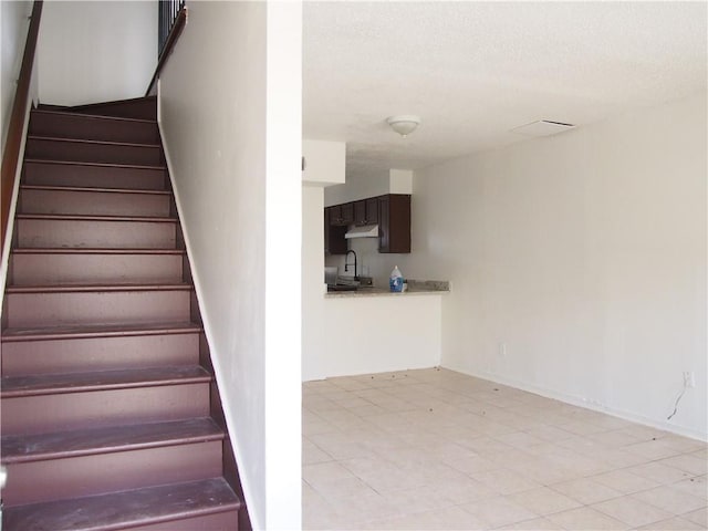 staircase with light tile floors