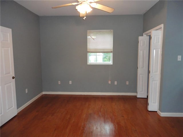 spare room featuring ceiling fan and dark hardwood / wood-style flooring