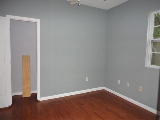 spare room featuring dark hardwood / wood-style floors and ceiling fan