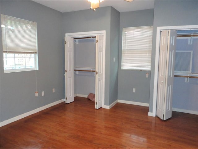 unfurnished bedroom with dark wood-type flooring