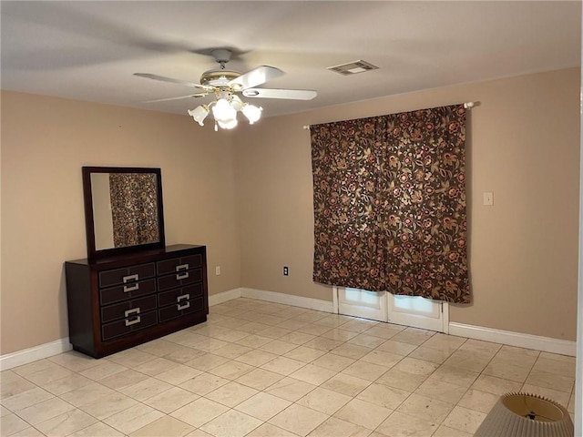 tiled empty room featuring ceiling fan