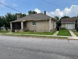 view of front of property with a front yard and a garage