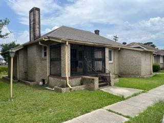 bungalow-style home featuring a front yard