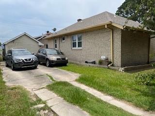 view of side of property with a lawn