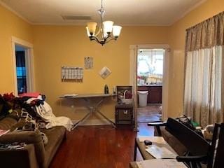 living room with dark hardwood / wood-style flooring and a notable chandelier