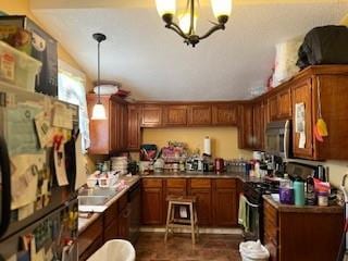 kitchen featuring a notable chandelier, hanging light fixtures, and range