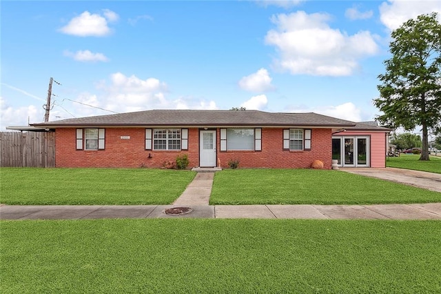 ranch-style home featuring a front lawn and french doors