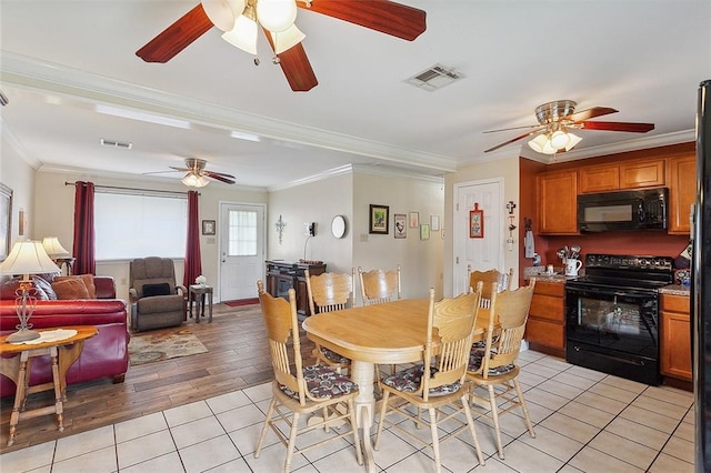 tiled dining room with ornamental molding and ceiling fan