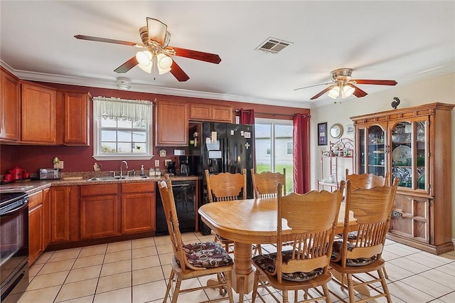 kitchen featuring light stone counters, ceiling fan, light tile floors, sink, and black appliances