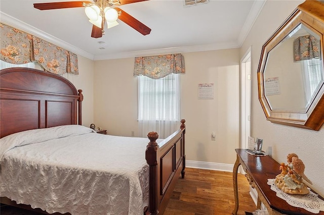 bedroom with ceiling fan, crown molding, and dark wood-type flooring