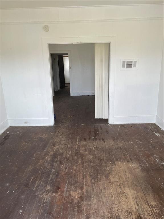 unfurnished room with dark wood-type flooring