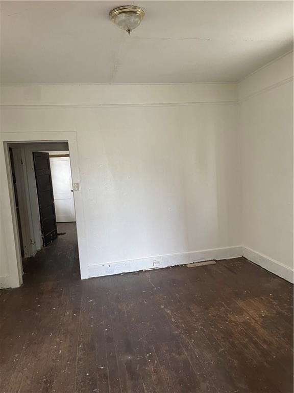 unfurnished room with dark hardwood / wood-style floors