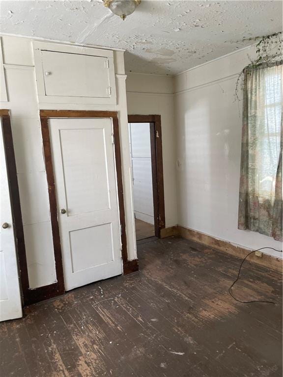 unfurnished bedroom with dark wood-type flooring