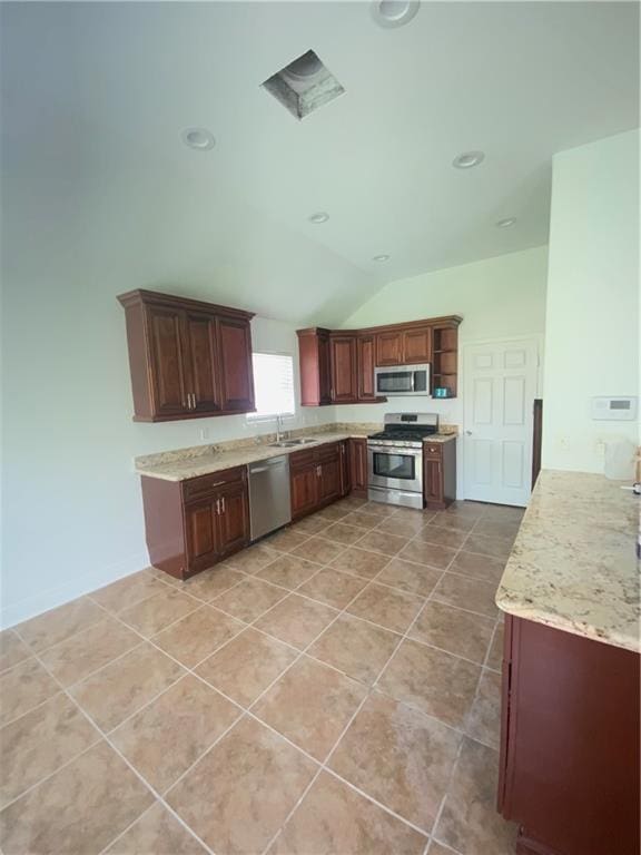 kitchen with light tile flooring, light stone counters, lofted ceiling, stainless steel appliances, and sink