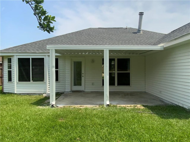 back of house featuring a lawn and a patio area