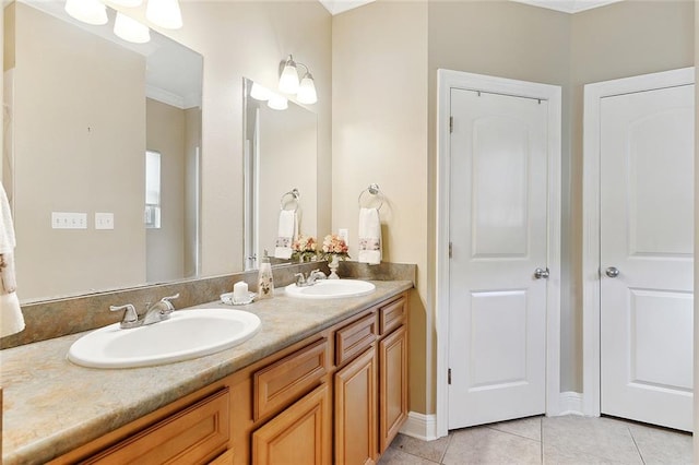 bathroom with double sink, ornamental molding, tile flooring, and vanity with extensive cabinet space